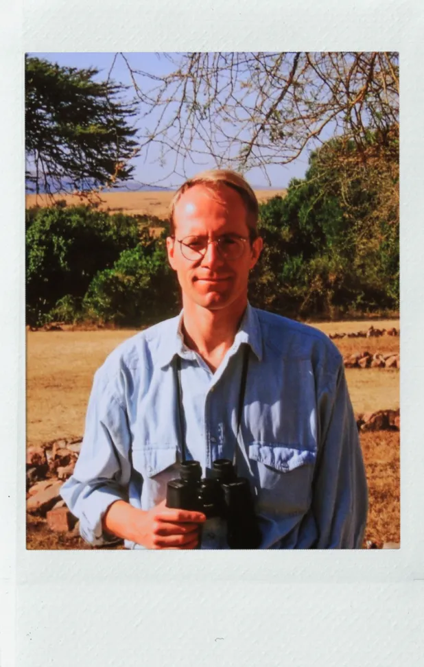 Norman Ward in the savannah with binoculars